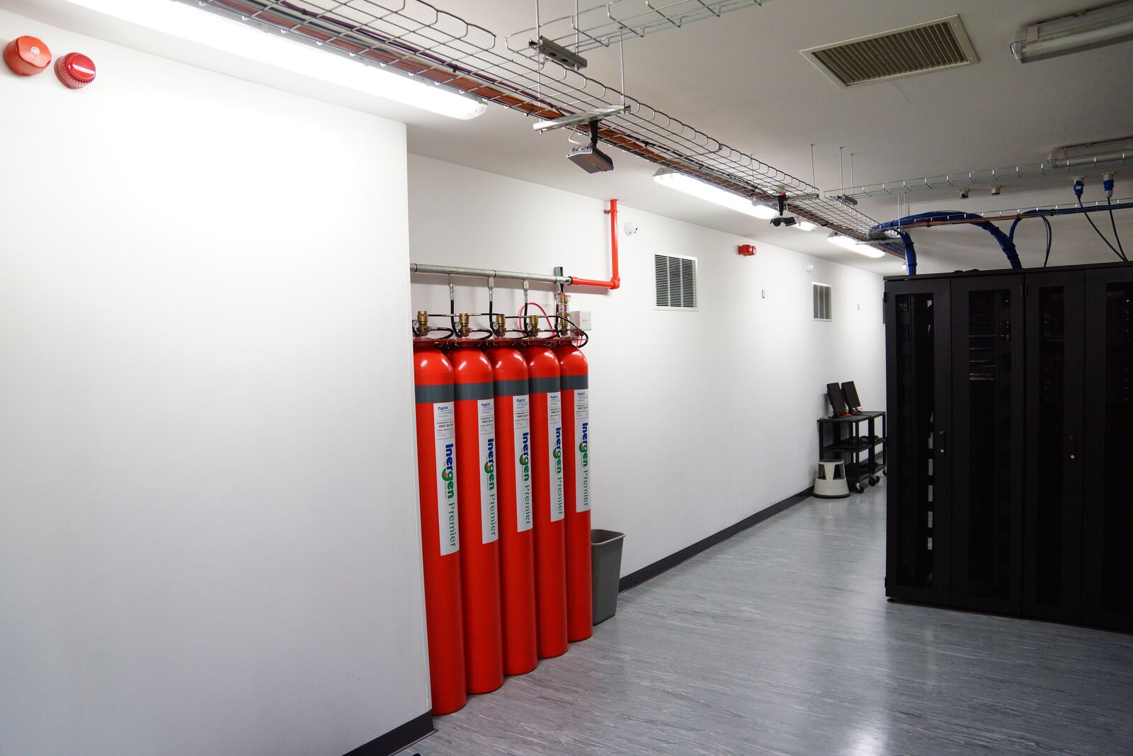 Inert-gas fire suppression cylinders beside the racks at Reliance House