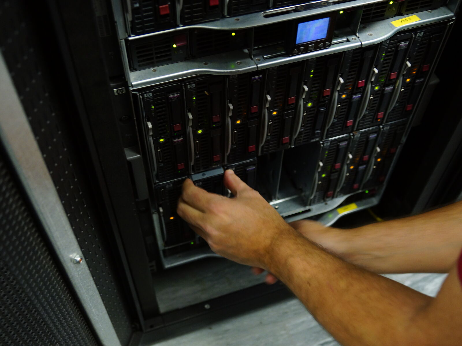 A Wildcard engineer working on a server chassis in the Reliance House datacentre